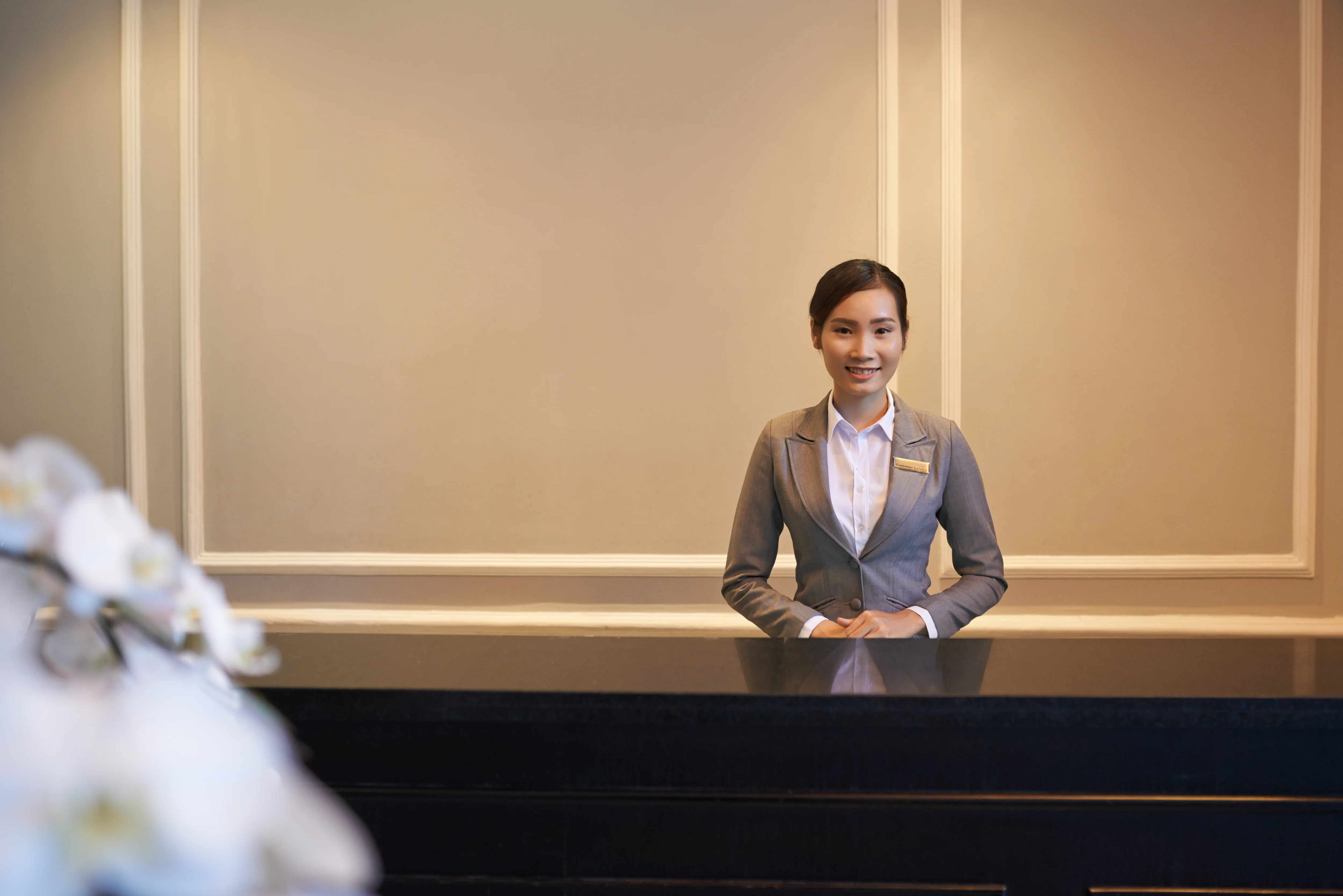 How to hire a private concierge — professional concierge at luxury reception desk, representing boutique concierge services by Cadiz & Lluis